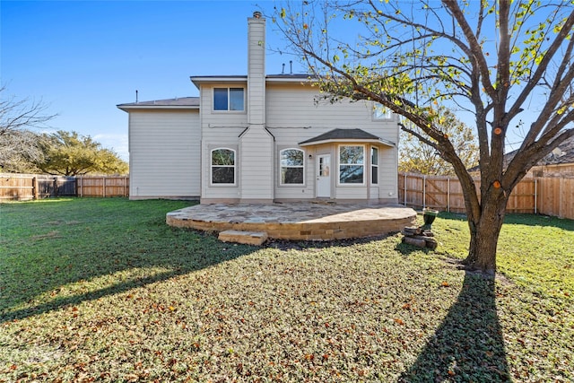 back of property with a patio area and a lawn