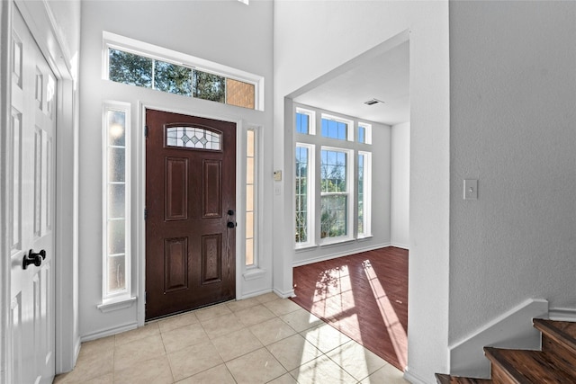 tiled foyer featuring a high ceiling