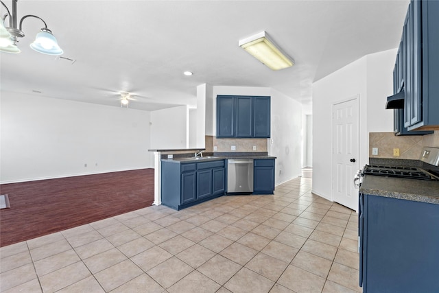 kitchen featuring blue cabinetry, decorative backsplash, hanging light fixtures, and stainless steel appliances