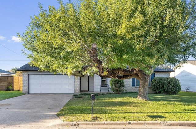 obstructed view of property featuring a front yard and a garage