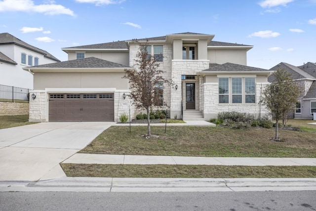 prairie-style home with a garage and a front lawn