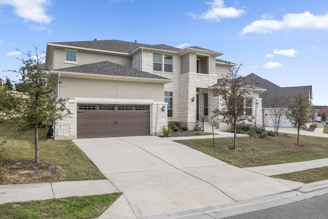 view of front facade with a garage and a front lawn