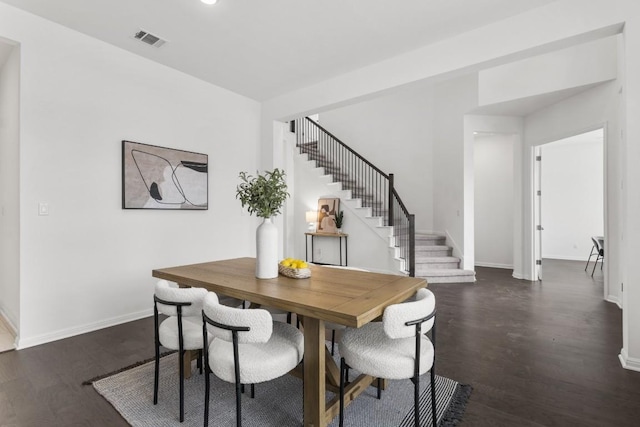 dining area with dark hardwood / wood-style flooring