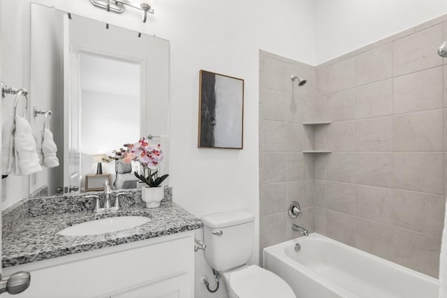 full bathroom featuring vanity, toilet, and tiled shower / bath