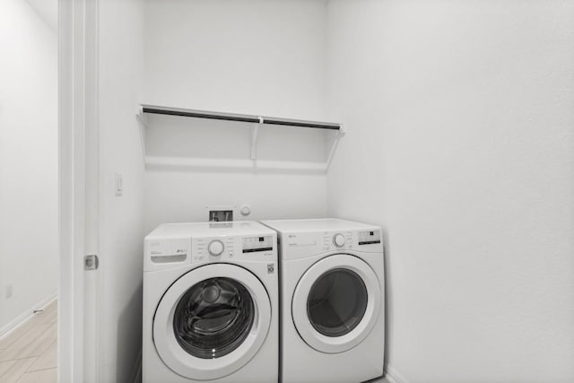 clothes washing area with washing machine and clothes dryer