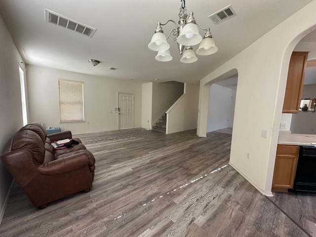 living room featuring a chandelier and dark hardwood / wood-style floors