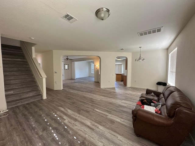 living room featuring a notable chandelier and wood-type flooring