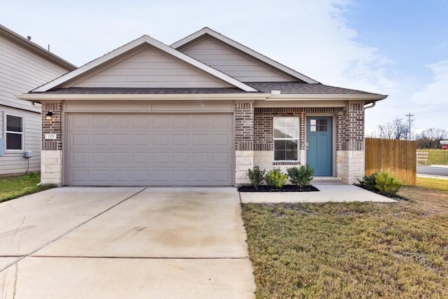 view of front of property featuring a front yard and a garage