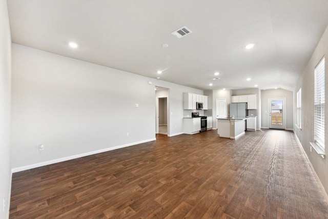 unfurnished living room featuring dark hardwood / wood-style flooring and lofted ceiling