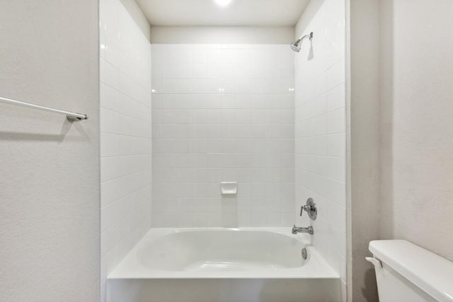 bathroom with toilet and bathing tub / shower combination