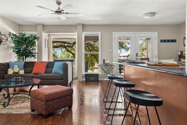 living room featuring dark hardwood / wood-style floors, ceiling fan, beverage cooler, and french doors