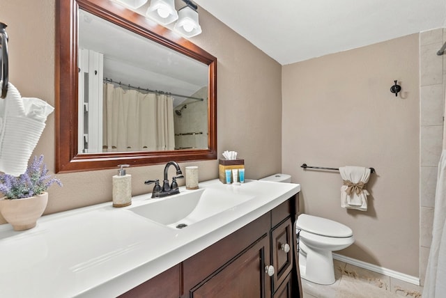 bathroom featuring vanity, curtained shower, and toilet