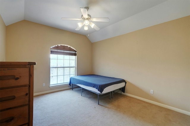 carpeted bedroom with ceiling fan and lofted ceiling