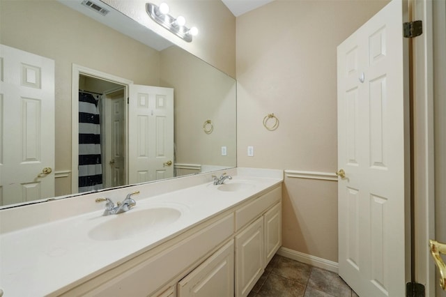 bathroom with tile patterned flooring and vanity