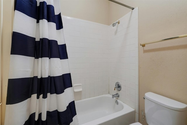 bathroom with shower / bath combination with curtain and toilet