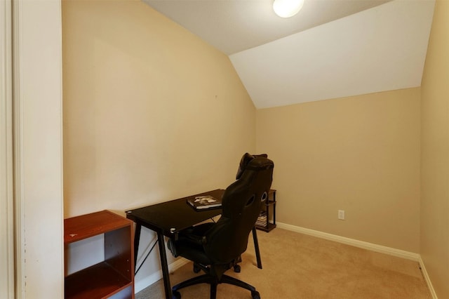 carpeted office space featuring lofted ceiling