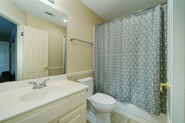 full bathroom with tile patterned flooring, shower / bath combination with curtain, vanity, and toilet