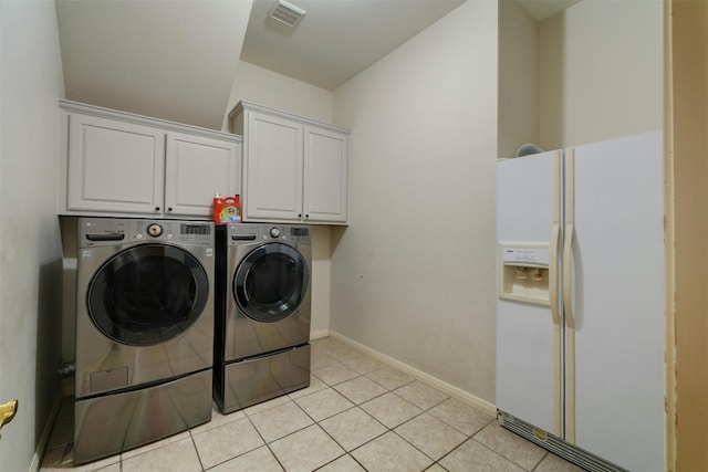 laundry room with light tile patterned flooring, cabinets, and independent washer and dryer