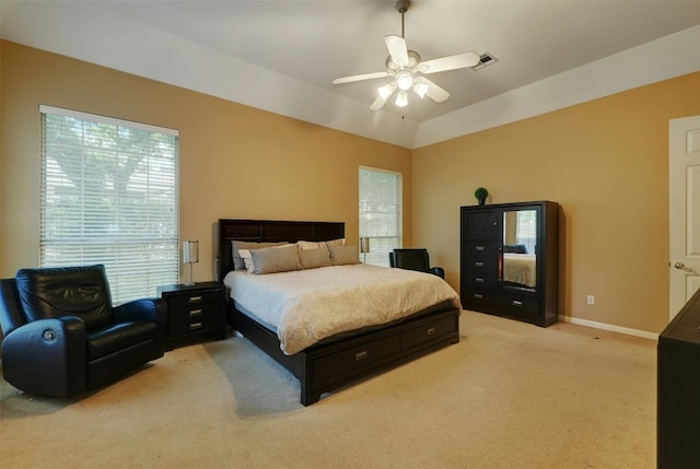 carpeted bedroom with vaulted ceiling and ceiling fan