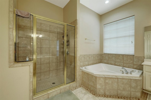 bathroom with tile patterned floors, separate shower and tub, and vanity