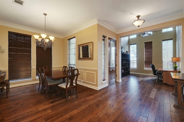 dining room with crown molding, dark wood-type flooring, and a notable chandelier