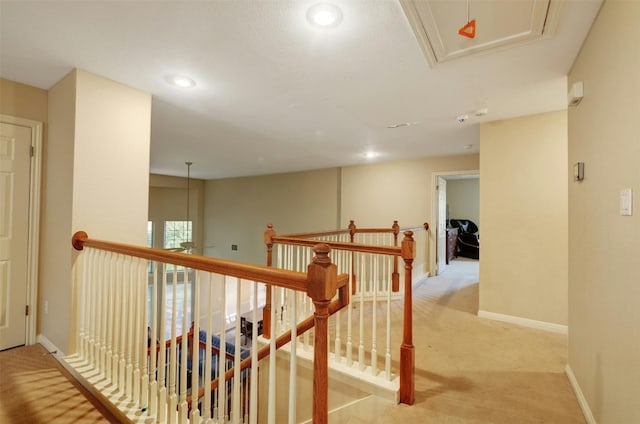 corridor featuring light colored carpet