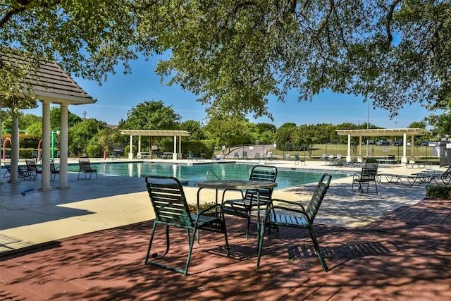 view of swimming pool with a pergola and a patio