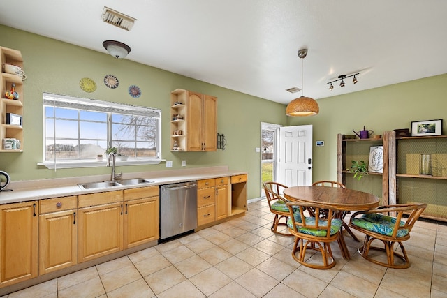 kitchen with dishwasher, light brown cabinets, sink, pendant lighting, and light tile patterned flooring