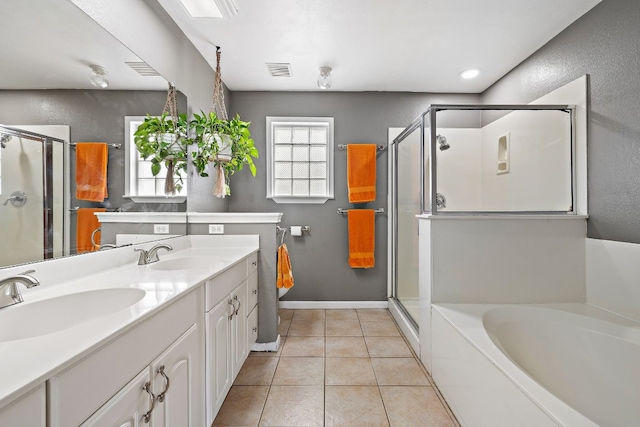 bathroom with plus walk in shower, vanity, and tile patterned flooring