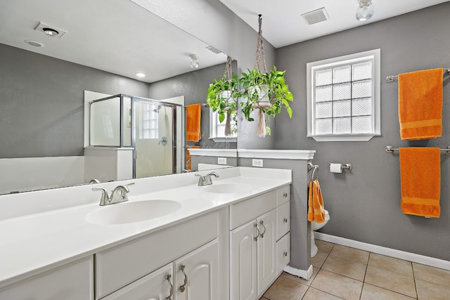 bathroom with tile patterned flooring, vanity, and a shower with shower door