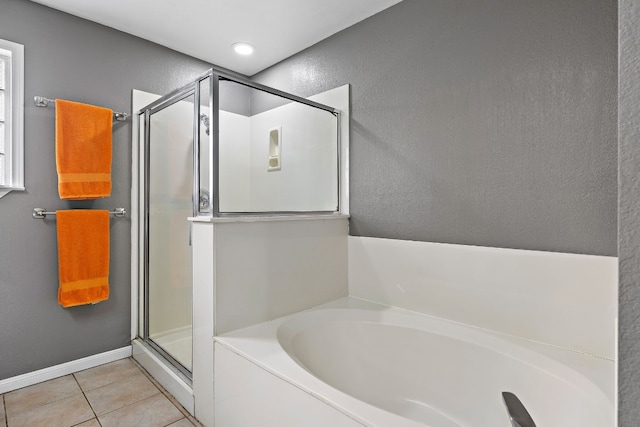 bathroom featuring shower with separate bathtub and tile patterned floors