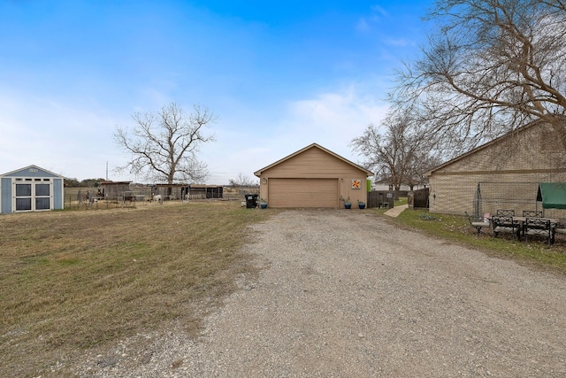 exterior space with a garage and an outbuilding