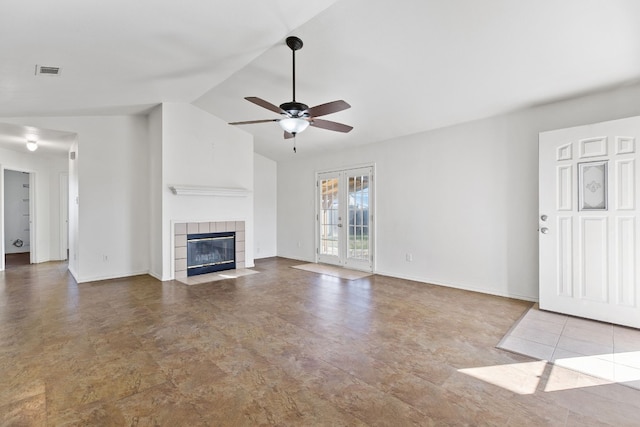 unfurnished living room featuring a tiled fireplace, ceiling fan, and vaulted ceiling