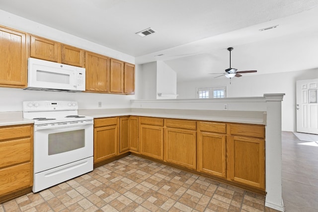 kitchen with kitchen peninsula, white appliances, vaulted ceiling, and ceiling fan