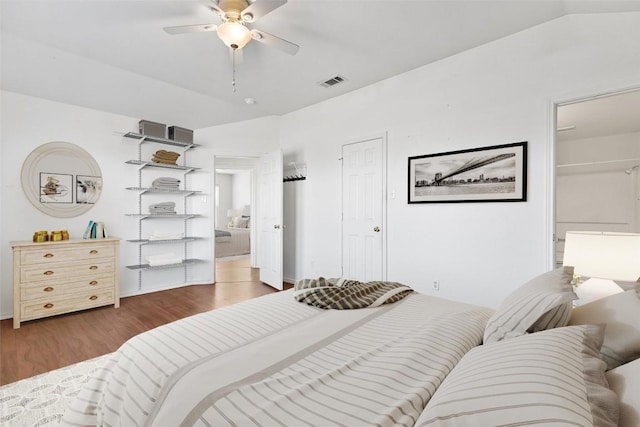 bedroom with dark hardwood / wood-style floors and ceiling fan