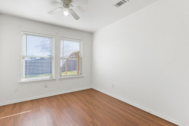 spare room featuring hardwood / wood-style floors and ceiling fan