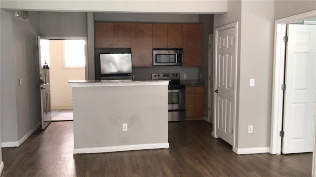 kitchen with stainless steel appliances and dark hardwood / wood-style floors