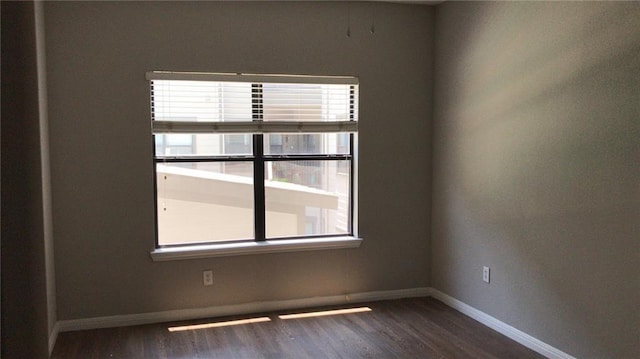 spare room featuring dark hardwood / wood-style flooring