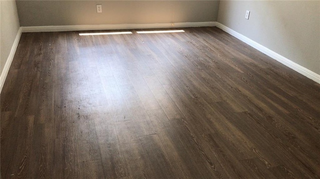 unfurnished room with dark hardwood / wood-style floors