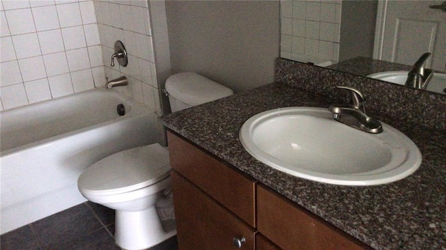 full bathroom featuring tile patterned floors, vanity, toilet, and tiled shower / bath combo