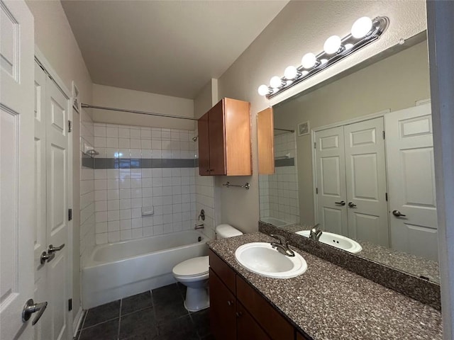 full bath featuring tile patterned floors, shower / bathtub combination, toilet, and vanity