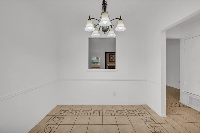 unfurnished dining area with a notable chandelier and light tile patterned flooring