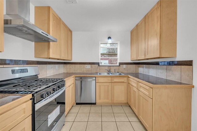 7209 Gunnison Pass, Austin, TX 78724 - kitchen featuring stainless steel appliances, wall chimney range hood, and light brown cabinets
