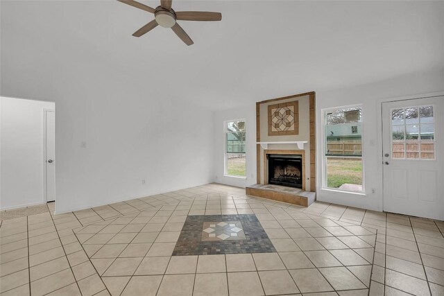 7209 Gunnison Pass, Austin, TX 78724 - unfurnished living room featuring light tile patterned floors, ceiling fan, and a tile fireplace