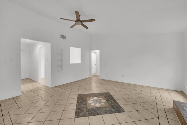 tiled empty room featuring high vaulted ceiling and ceiling fan