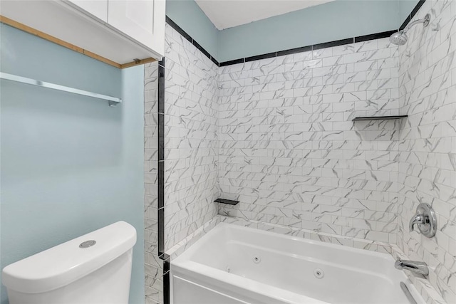 bathroom featuring toilet and tiled shower / bath