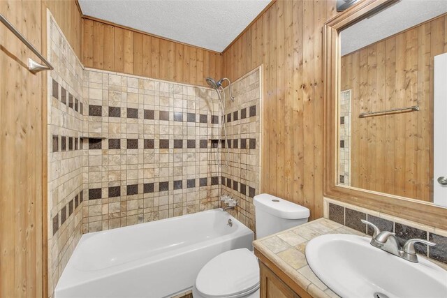 7209 Gunnison Pass, Austin, TX 78724 - bathroom with vanity, bathing tub / shower combination, a textured ceiling, and wood walls