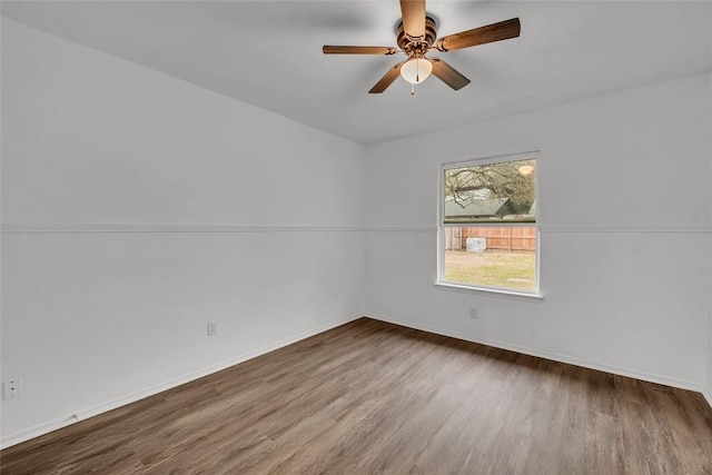 empty room featuring ceiling fan and dark hardwood / wood-style flooring