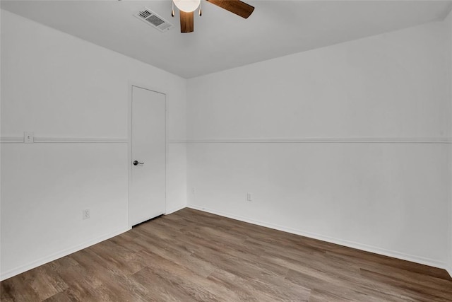 spare room with ceiling fan and hardwood / wood-style flooring