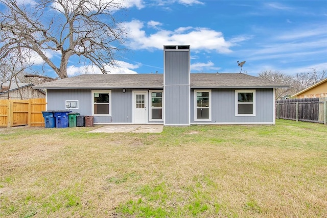 back of house with a lawn